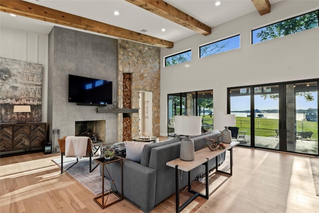 13555 Broken Arrow, Malakoff, TX 75148 - living room with a large fireplace, hardwood / wood-style floors, a high ceiling, and beam ceiling