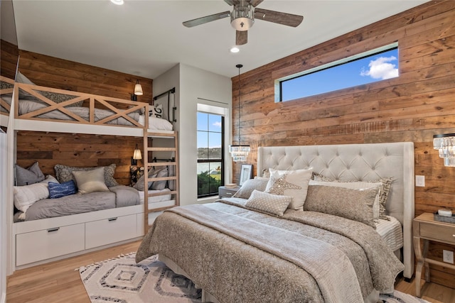 13555 Broken Arrow, Malakoff, TX 75148 - bedroom featuring a ceiling fan, light wood-style floors, wooden walls, and recessed lighting