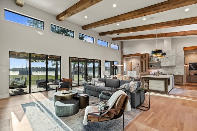 13555 Broken Arrow, Malakoff, TX 75148 - living area with beamed ceiling, light wood-style floors, plenty of natural light, and a towering ceiling