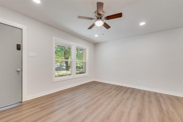 spare room with baseboards, recessed lighting, a ceiling fan, and light wood-style flooring