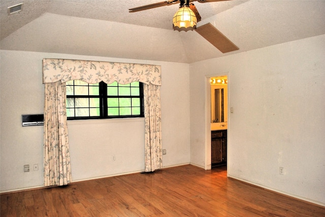 unfurnished room featuring vaulted ceiling, baseboards, visible vents, wood finished floors, and ceiling fan