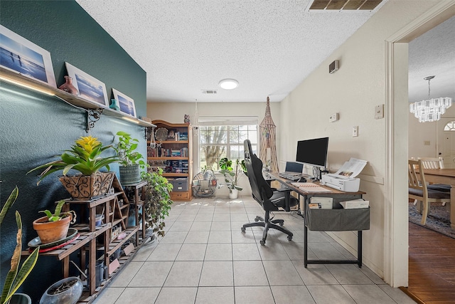 office area with visible vents, a textured ceiling, a notable chandelier, and light tile patterned floors