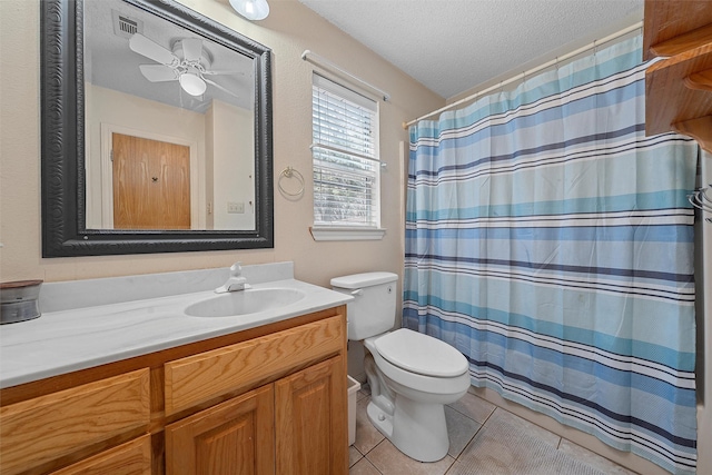 bathroom featuring tile patterned floors, a textured ceiling, toilet, a ceiling fan, and vanity