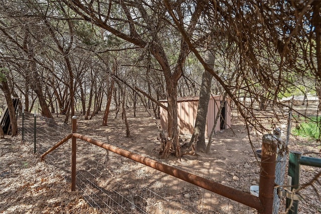 view of yard featuring an outdoor structure and fence