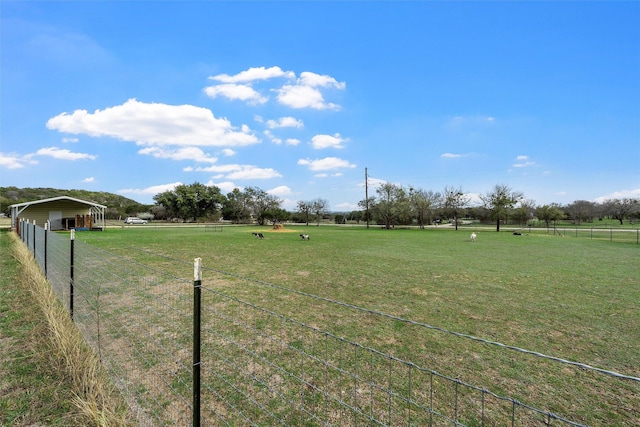 view of yard with a rural view and fence