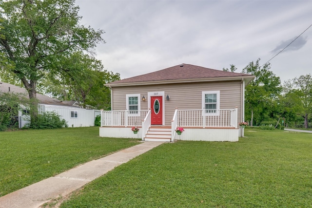 bungalow-style home featuring a front yard and covered porch