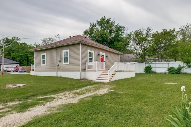manufactured / mobile home with stairway, fence, a front lawn, crawl space, and a deck