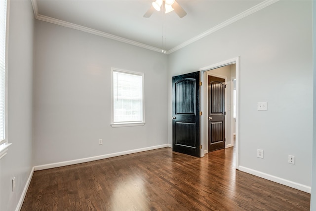empty room featuring a ceiling fan, baseboards, crown molding, and wood finished floors