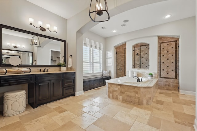 full bath with a garden tub, stone tile flooring, vanity, and a tile shower