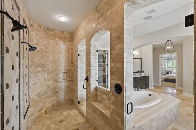 full bathroom featuring a bath, vanity, visible vents, a shower stall, and ensuite bath
