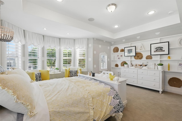 carpeted bedroom with recessed lighting and a raised ceiling