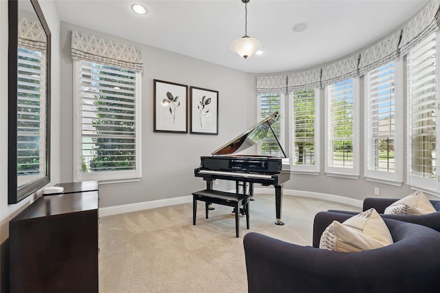 living area with plenty of natural light, baseboards, recessed lighting, and light colored carpet