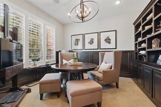 dining room featuring wainscoting, light carpet, recessed lighting, and a chandelier
