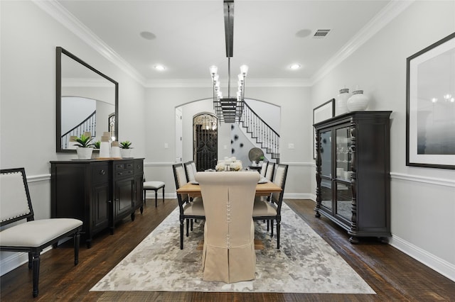 dining space featuring arched walkways, stairway, visible vents, and dark wood-style flooring