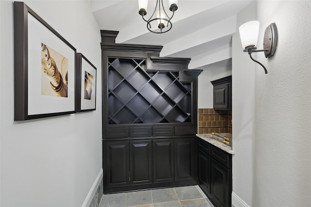 wine room with stone finish flooring and baseboards