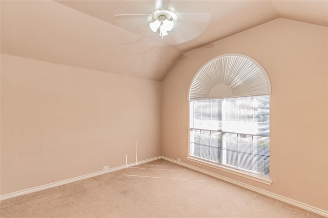 additional living space with lofted ceiling, a ceiling fan, baseboards, and carpet