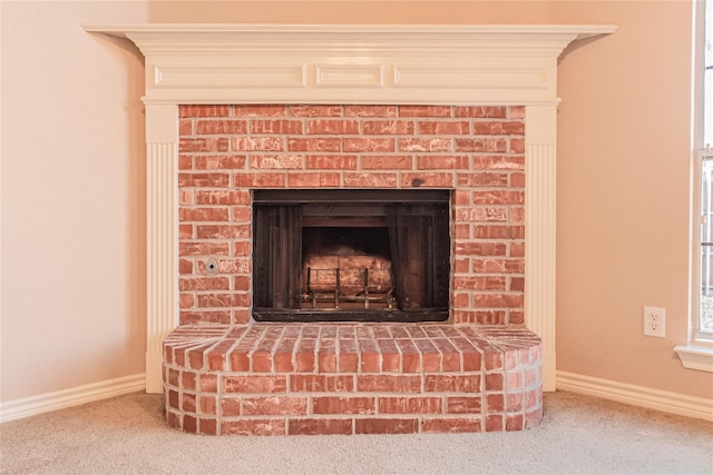 details featuring a fireplace, carpet, and baseboards