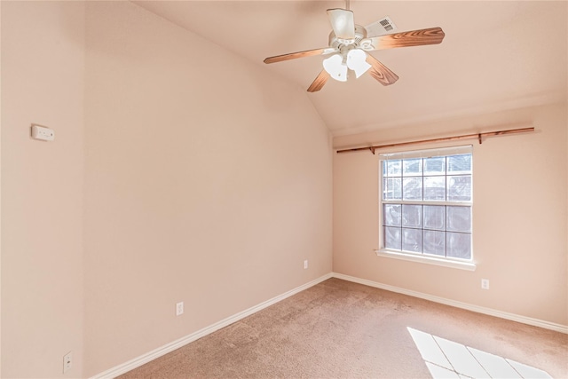 spare room with lofted ceiling, visible vents, baseboards, carpet flooring, and ceiling fan