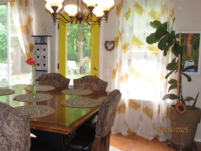 2709 Lakeside Dr, Burleson, TX 76028 - tiled dining space featuring a notable chandelier and a healthy amount of sunlight
