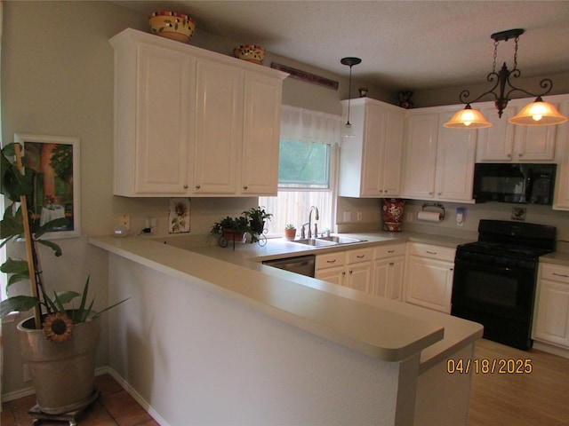 2709 Lakeside Dr, Burleson, TX 76028 - kitchen featuring black appliances, white cabinetry, a sink, and light countertops