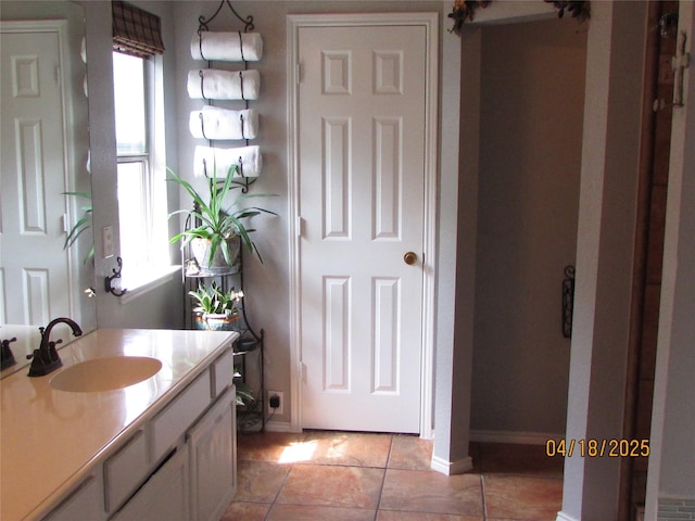 2709 Lakeside Dr, Burleson, TX 76028 - bathroom with baseboards, vanity, and tile patterned flooring