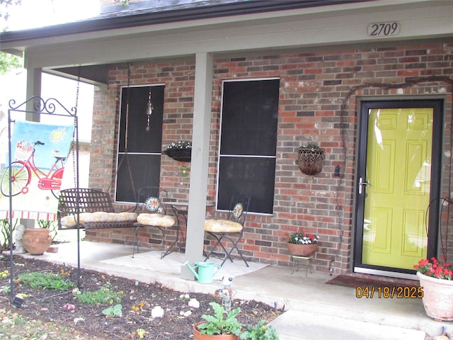 2709 Lakeside Dr, Burleson, TX 76028 - property entrance featuring a porch and brick siding