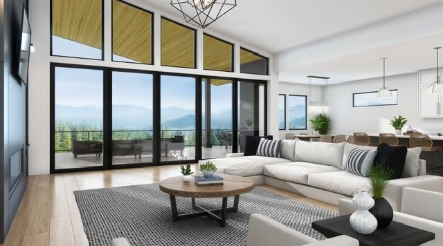 living area featuring floor to ceiling windows, a mountain view, and light wood-style flooring