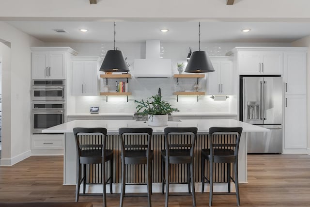 1236 Monterra Way, Fate, TX 75087 - kitchen featuring stainless steel appliances, wall chimney exhaust hood, a kitchen island, open shelves, and recessed lighting