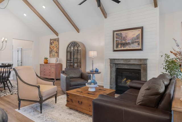 1236 Monterra Way, Fate, TX 75087 - living room featuring light wood-type flooring, beamed ceiling, ceiling fan, recessed lighting, and a glass covered fireplace