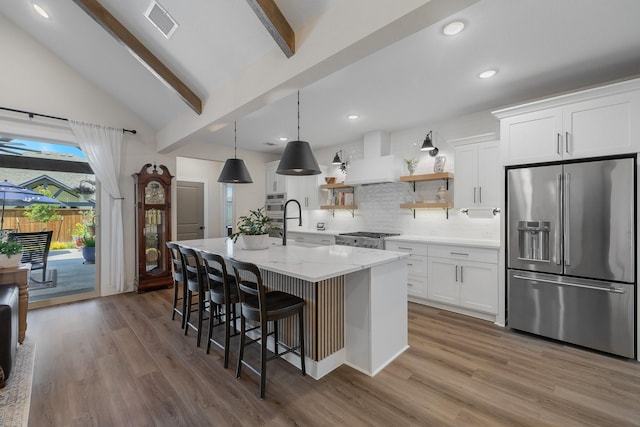 1236 Monterra Way, Fate, TX 75087 - kitchen featuring high quality fridge, white cabinets, a center island with sink, tasteful backsplash, and recessed lighting