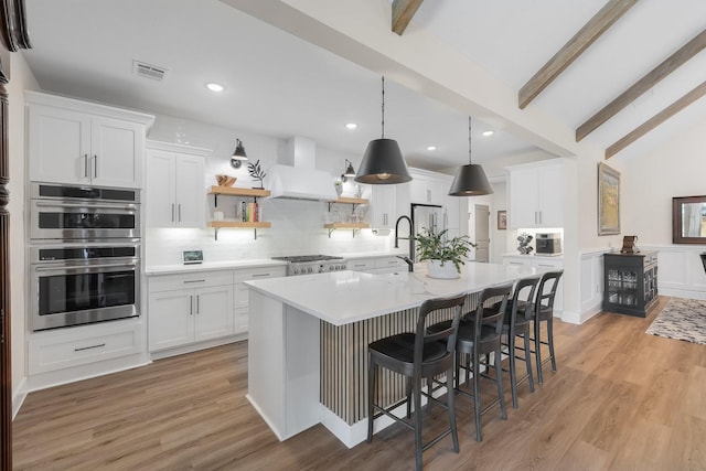 1236 Monterra Way, Fate, TX 75087 - kitchen featuring stainless steel appliances, exhaust hood, open shelves, a kitchen island, and recessed lighting