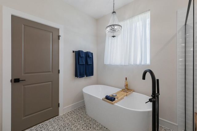 1236 Monterra Way, Fate, TX 75087 - full bathroom featuring baseboards, a soaking tub, a chandelier, and tile patterned floors
