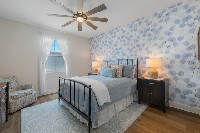 1236 Monterra Way, Fate, TX 75087 - bedroom with baseboards, wood finished floors, a ceiling fan, and wallpapered walls