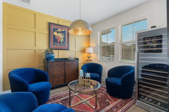 1236 Monterra Way, Fate, TX 75087 - sitting room with wood finished floors, wine cooler, and a decorative wall