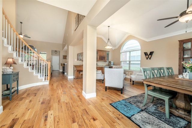 7612 Trevino Dr, Plano, TX 75025 - entrance foyer featuring ceiling fan, stairway, light wood-type flooring, baseboards, and high vaulted ceiling