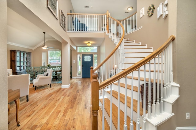 7612 Trevino Dr, Plano, TX 75025 - entryway with wood finished floors, stairway, ceiling fan, ornamental molding, and baseboards