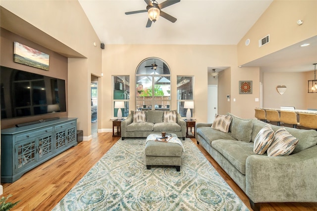 7612 Trevino Dr, Plano, TX 75025 - living room with a ceiling fan, high vaulted ceiling, wood finished floors, and baseboards