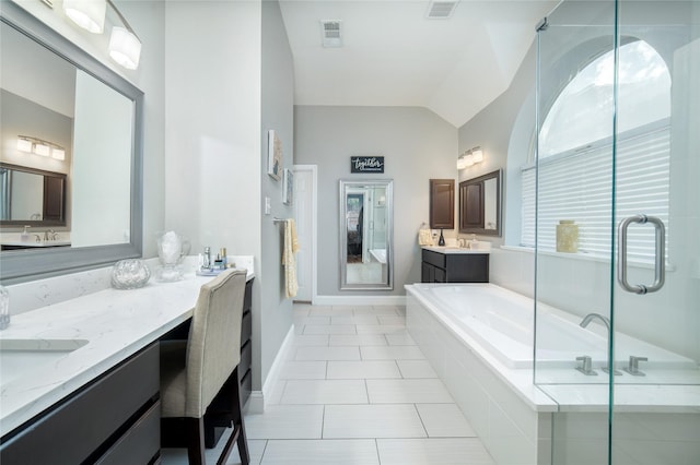 7612 Trevino Dr, Plano, TX 75025 - bathroom with lofted ceiling, a bath, a stall shower, and tile patterned flooring