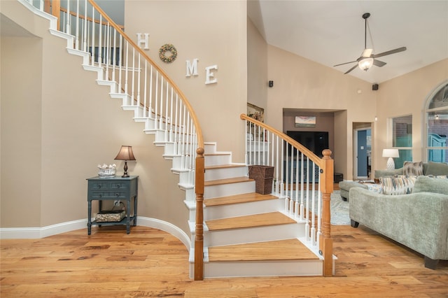 7612 Trevino Dr, Plano, TX 75025 - staircase featuring high vaulted ceiling, ceiling fan, wood finished floors, and baseboards