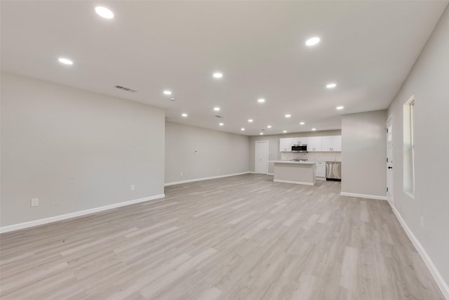 1005 Osborne Ln, Fort Worth, TX 76112 - unfurnished living room with baseboards, light wood-style floors, visible vents, and recessed lighting