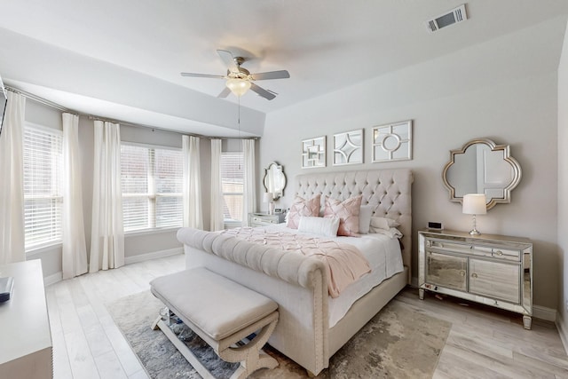 bedroom with ceiling fan, baseboards, light wood-style floors, and visible vents