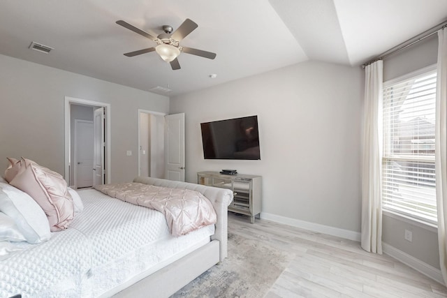 bedroom featuring baseboards, visible vents, light wood-style floors, and ceiling fan