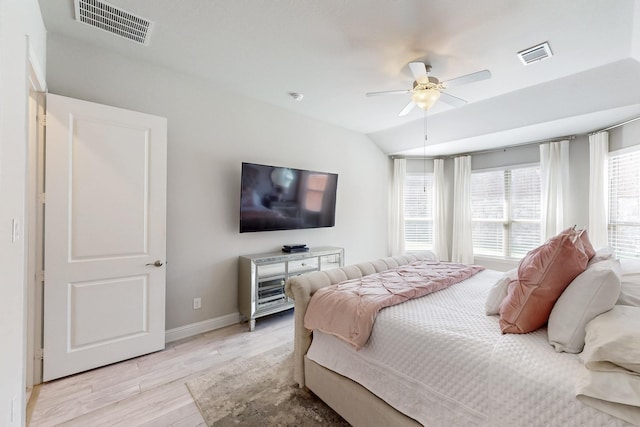 bedroom featuring light wood-type flooring, baseboards, a ceiling fan, and visible vents