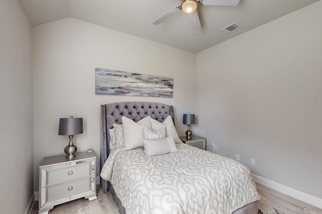 bedroom with visible vents, light wood finished floors, baseboards, and a ceiling fan