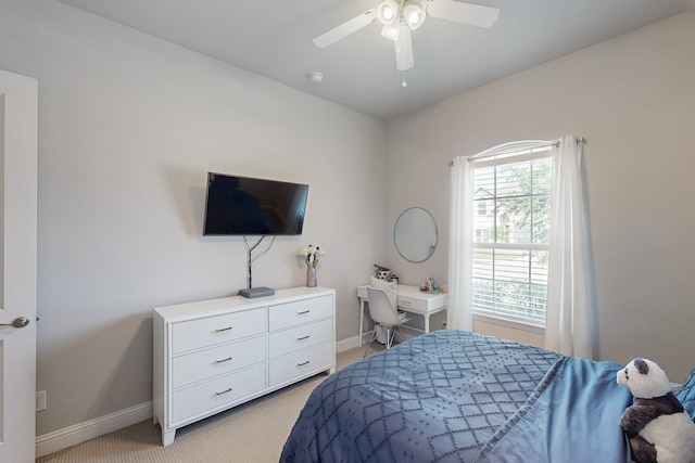 bedroom featuring baseboards, a ceiling fan, and light colored carpet