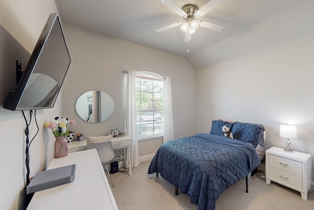 bedroom with ceiling fan, light carpet, vaulted ceiling, and baseboards