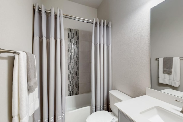 bathroom featuring shower / bath combination with curtain, a textured wall, vanity, and toilet