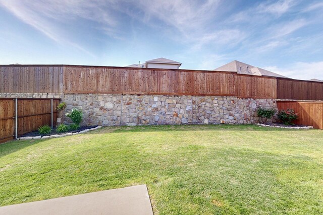 view of yard with a fenced backyard