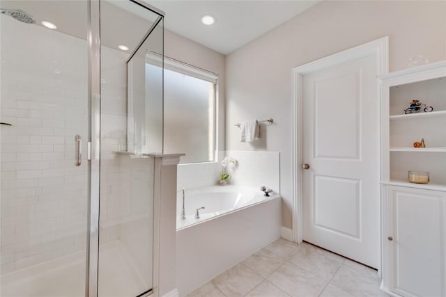 bathroom featuring a garden tub and a stall shower