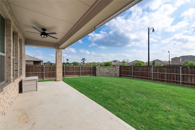 view of yard featuring a patio area, a ceiling fan, and a fenced backyard